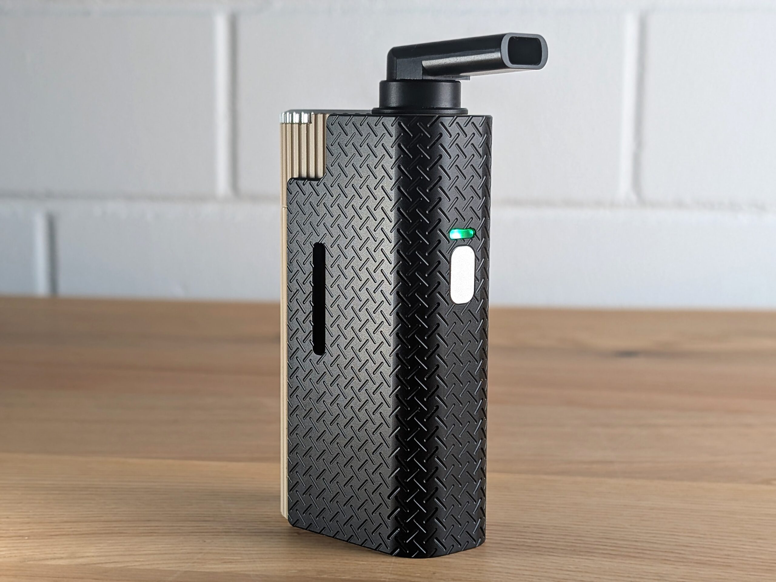 Frolic Thermal Extractor standing on a wooden table with blurred white brick wall in background