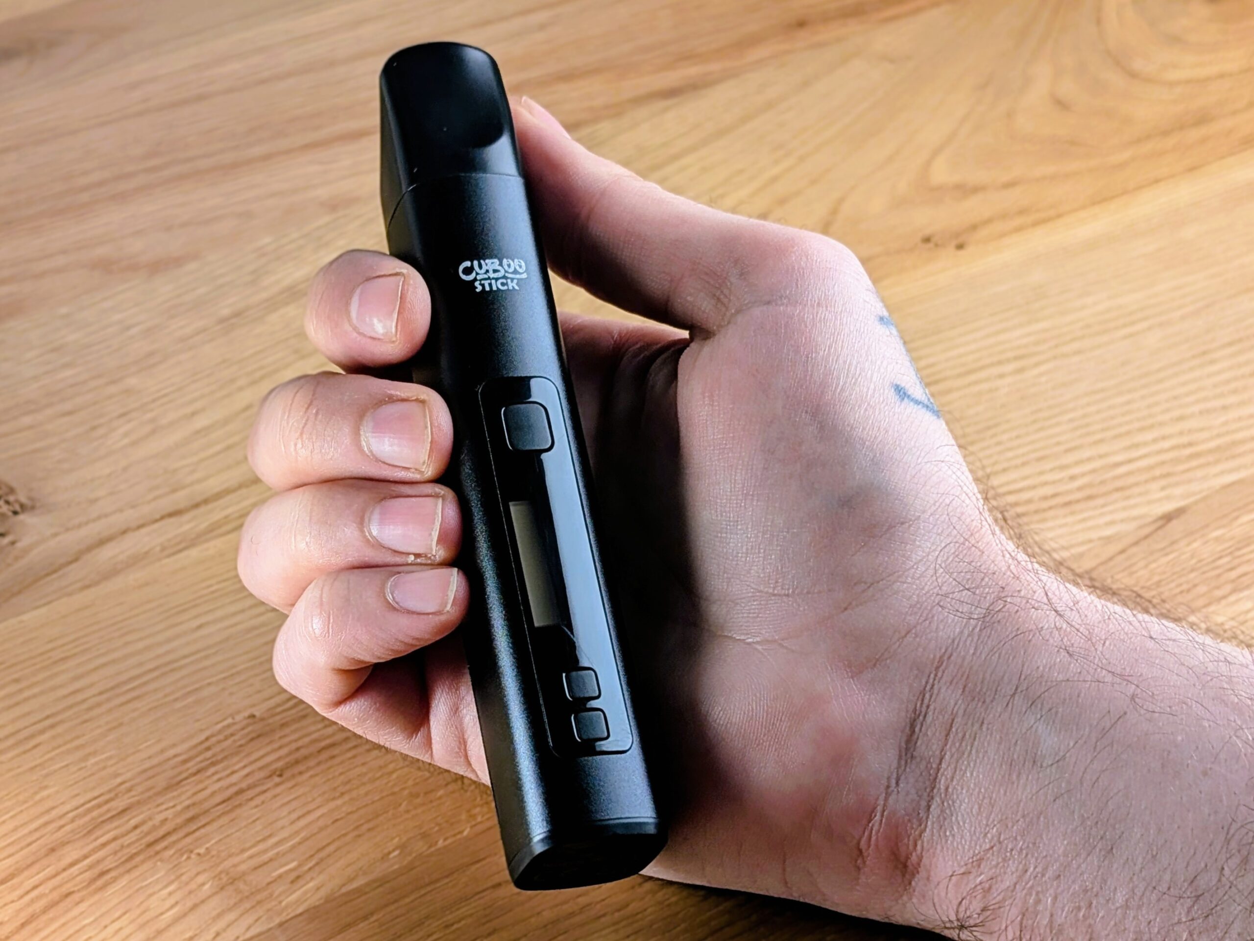 Eine Hand hält den Cuboo Stick.