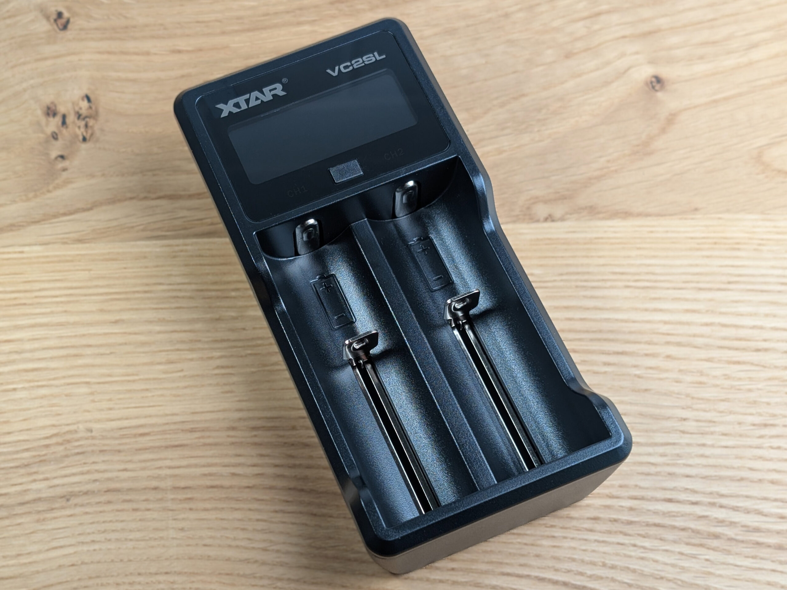 The XTAR charger sits on a table.