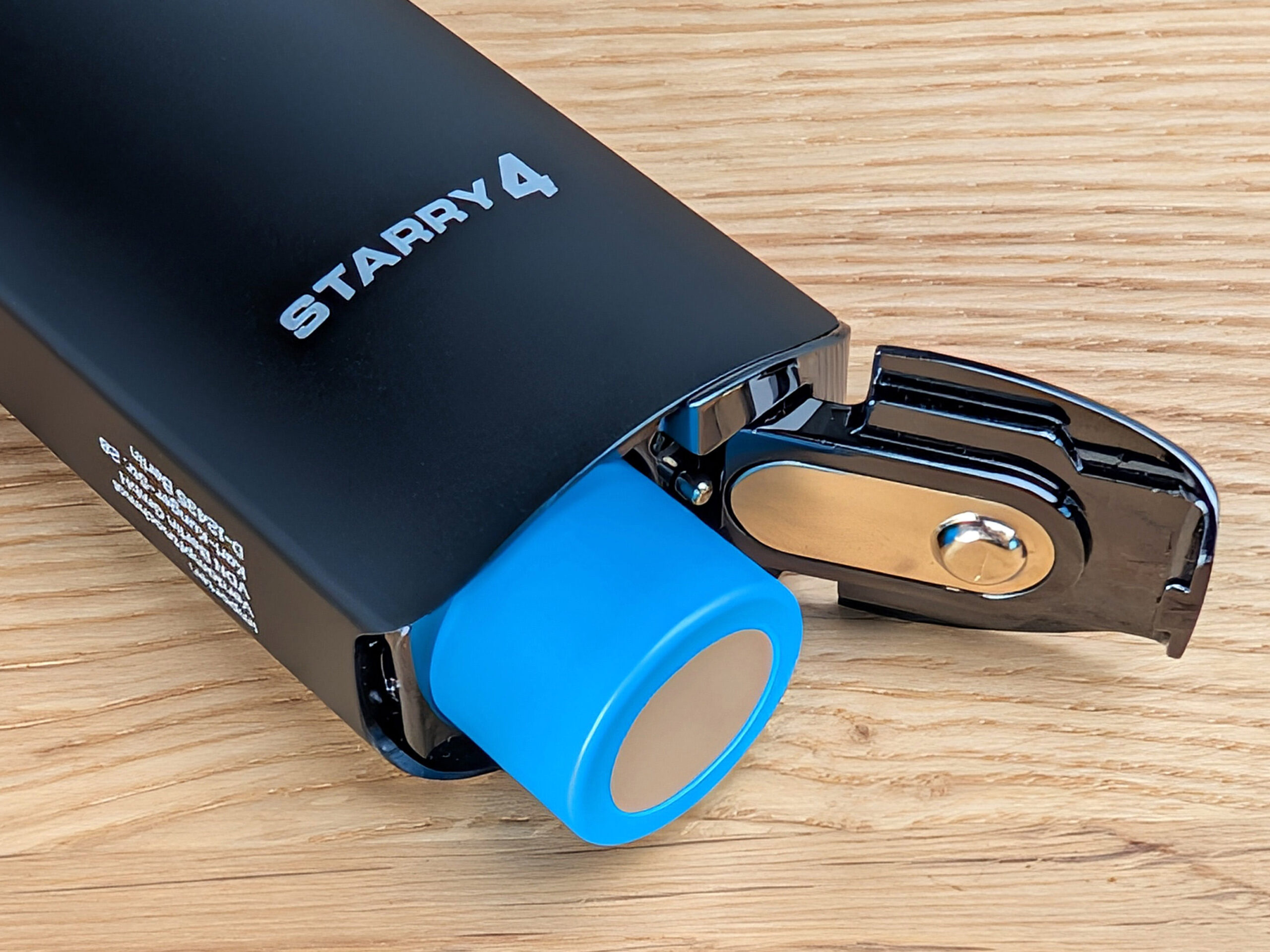 The Starry 4 Vaporizer with its battery compartment open and part of the battery visible.