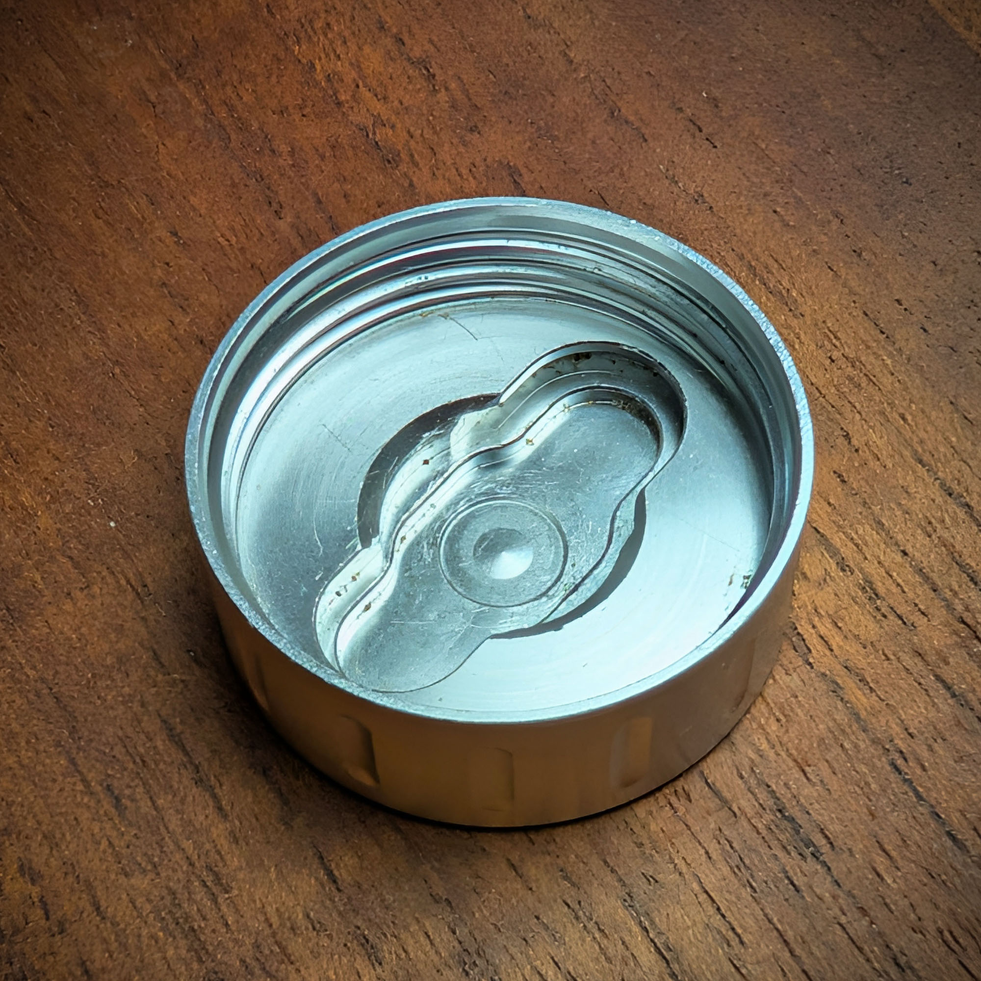 The decapper of the Mad Heaters Reload 3 lying on a wooden table.