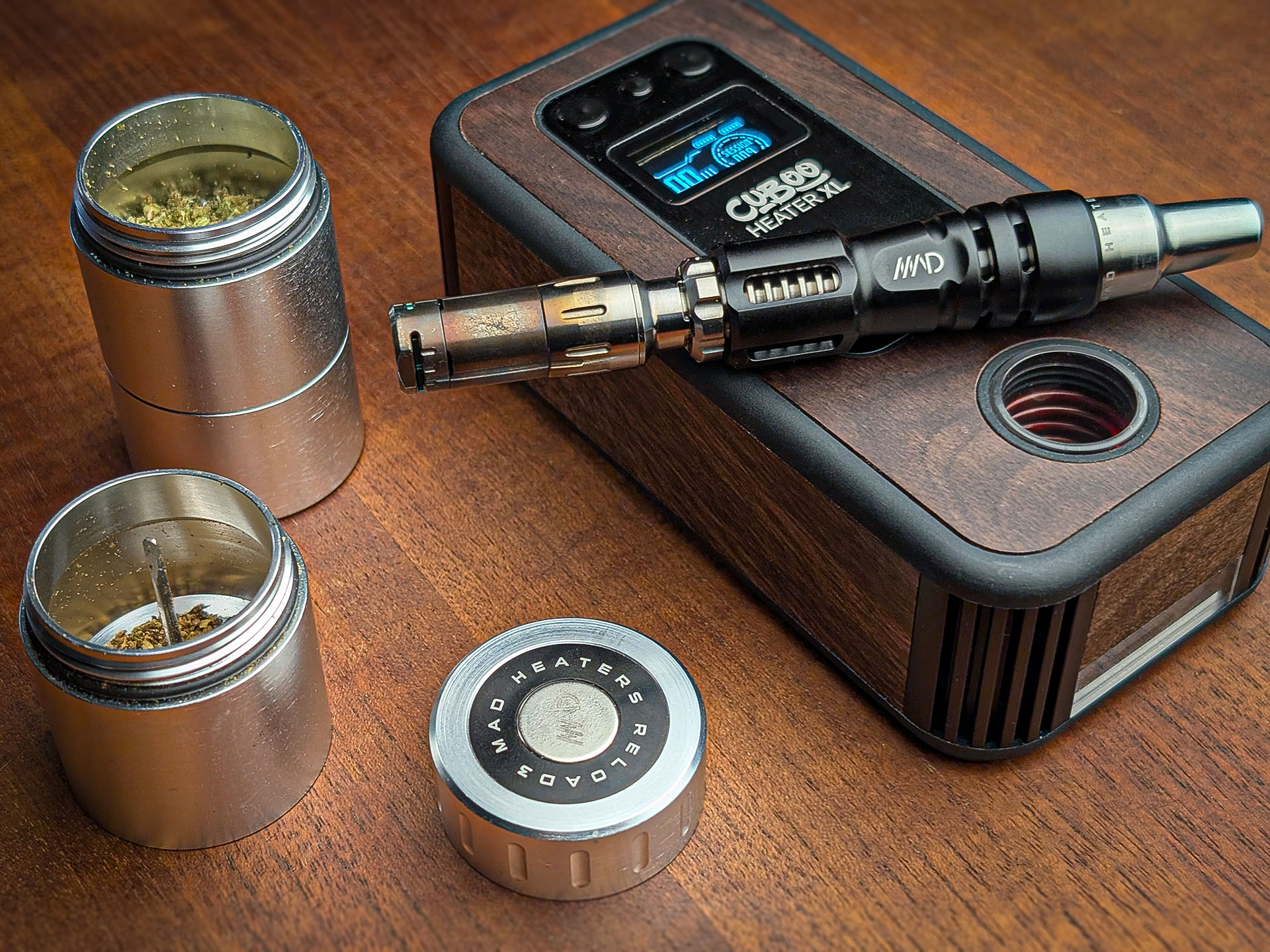 Mad Heaters Reload 3, Tempest 2 and Cuboo Heater XL are lying on a wooden table.