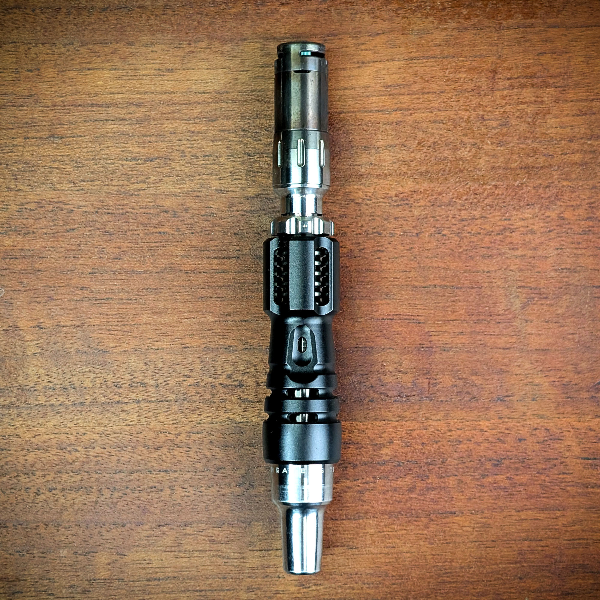 The Mad Heaters Tempest 2 is lying on a wooden table.