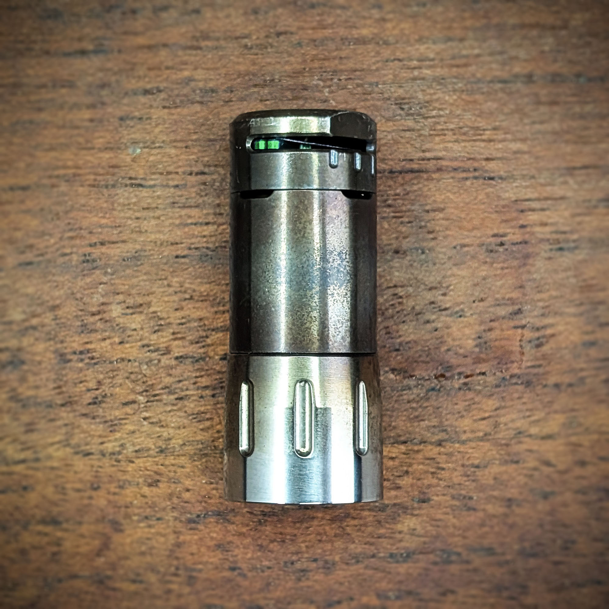 The heating cap of the Mad Heater Tempest 2 is lying on a wooden table.