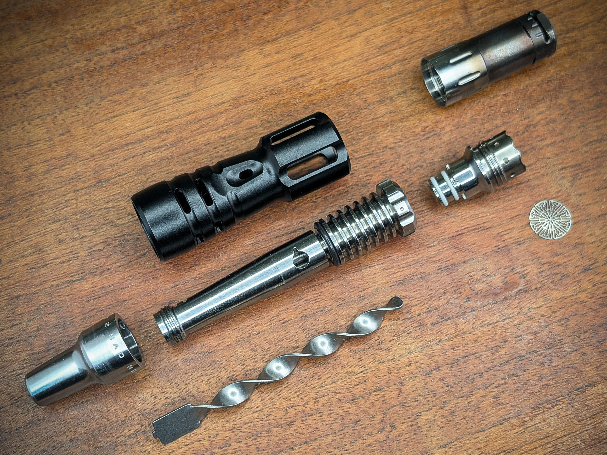 The Mad Heaters Tempest 2 lies, dismantled into its individual parts, on a wooden table.