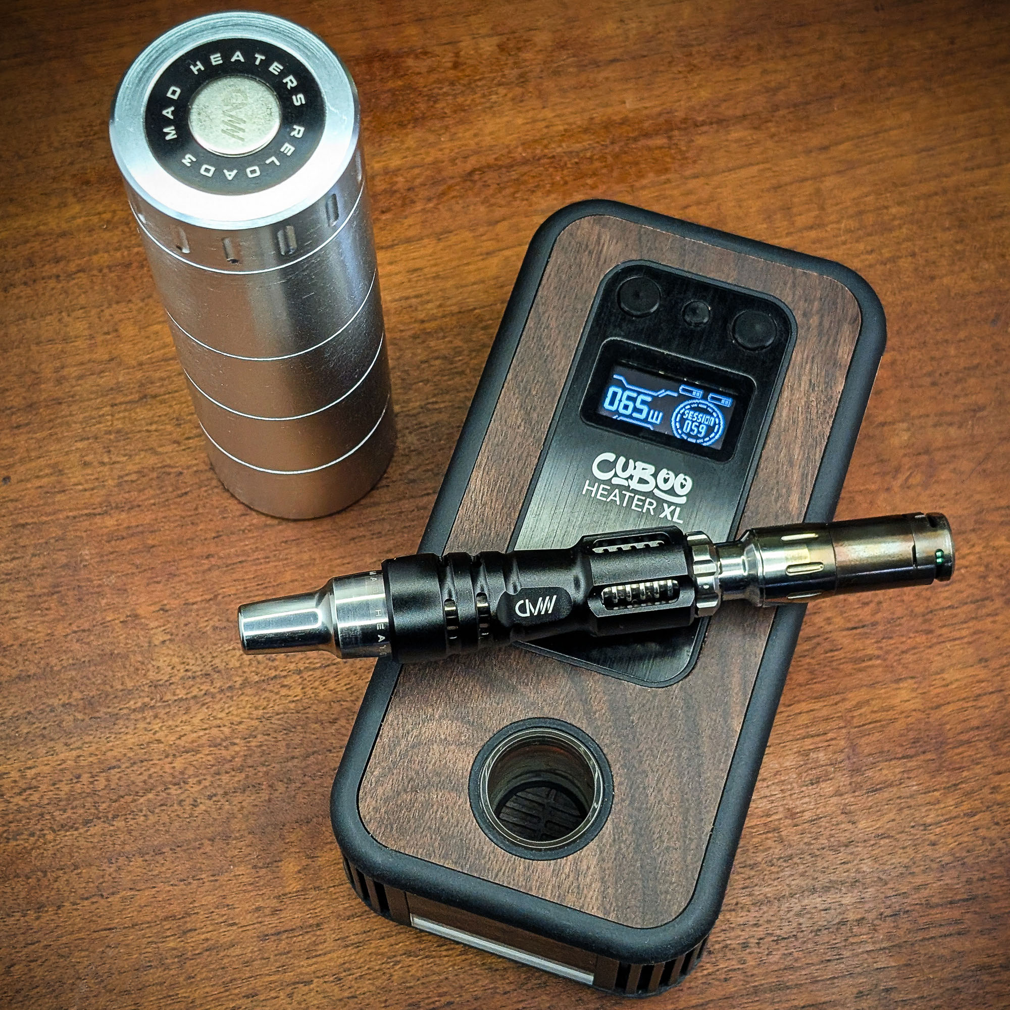 Mad Heaters Reload 3, Tempest 2 and Cuboo Heater XL are lying on a wooden table.