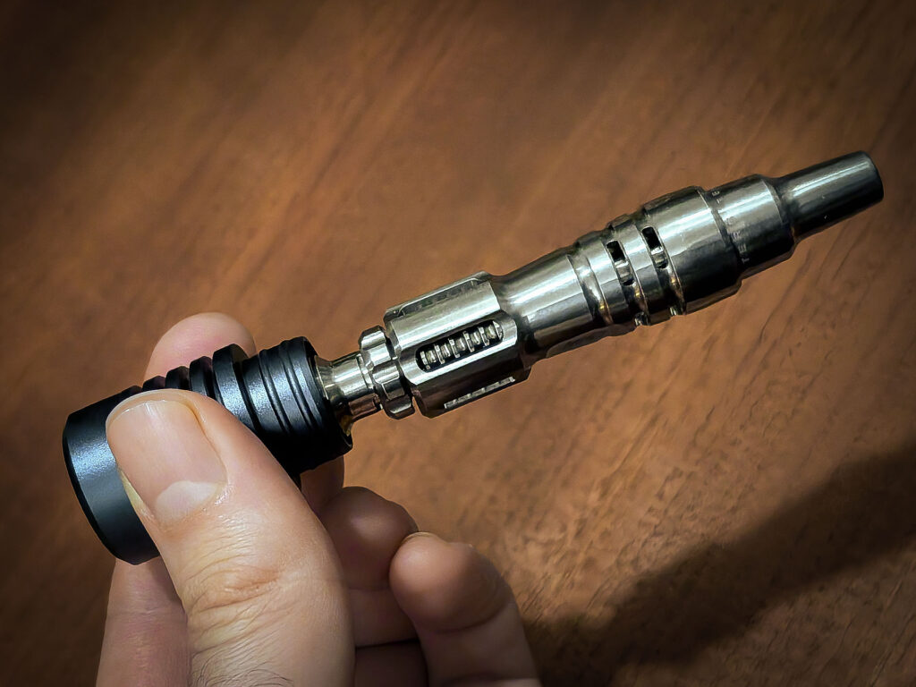 One hand holds the magnetic lid of the Tempest Case containing the Mad Heaters Tempest 2.